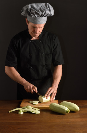 chef cutting a zucchiniの写真素材