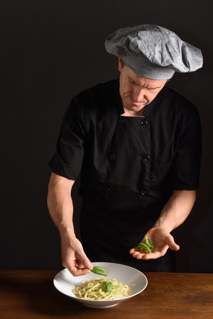chef preparing a plate of spaghettiの写真素材