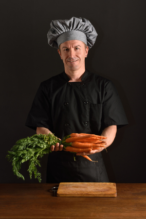 chef chopping a carrotの写真素材