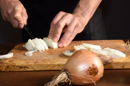 detail of a chef chopping onionsの写真素材