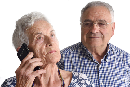 Portrait of a couple senior talking for movil phoneの写真素材