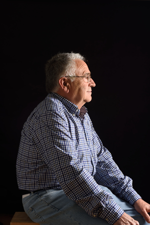 Portrait of a senior man with black backgroundの写真素材
