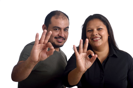 Couple doing the ok sign on whiteの写真素材