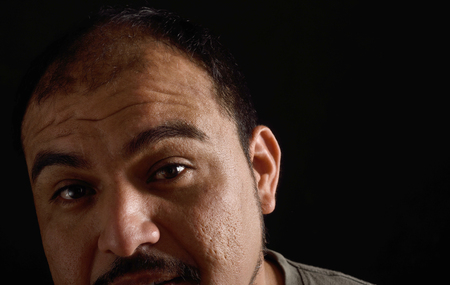 Portrait of a latin man on black background