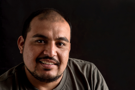 Portrait of a latin man on black backgroundの写真素材