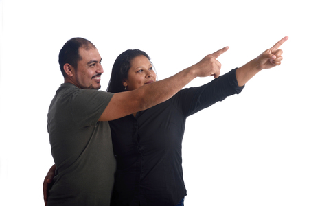 latinamerican couple point in whiteの写真素材