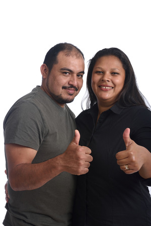 Couple doing the sign thumbs up on white backgroundの写真素材