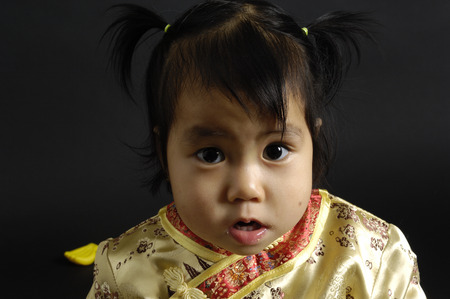 Portrait of a chinese girl on black backgroundの写真素材