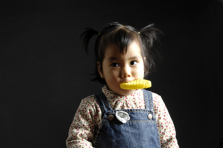 Portrait of a chinese girl on black backgroundの写真素材