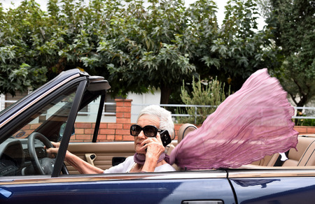 senior woman talking with mobile in the carの写真素材