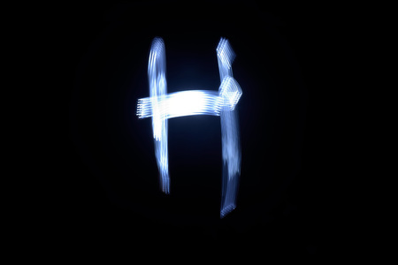 paint with light on black background letter Hの写真素材