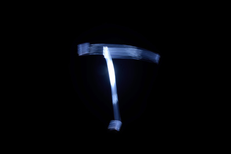 paint with light on black background letter Tの写真素材