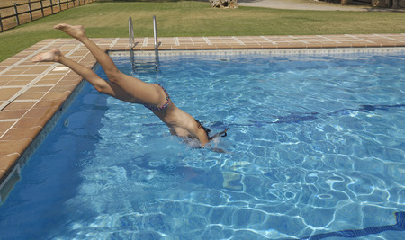 Woman jumping in the pool