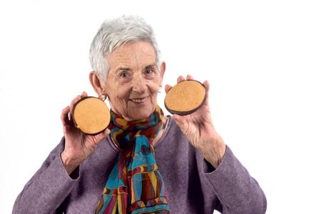 senior woman eating cookie
 on white backgroundの写真素材