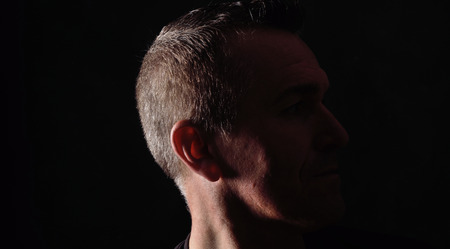 portrait of a man on black backgroundの写真素材