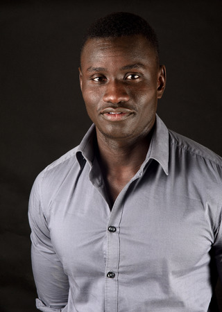 portrait of an african young man on blackの写真素材