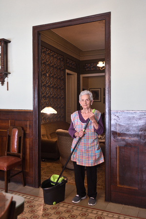 Older woman with mop making the floor of her houseの写真素材