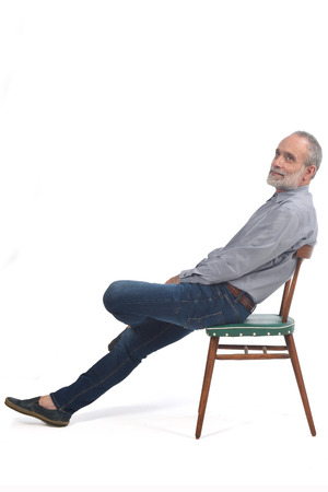 Portrait of a middle aged man sitting on a chairの写真素材