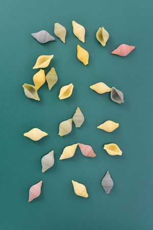Pasta  conchiglie on green backgroundの写真素材