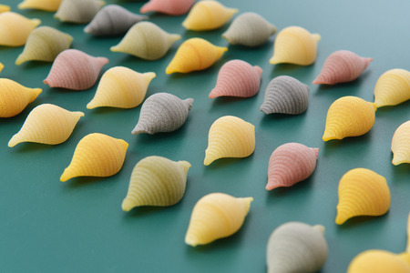 Pasta  conchiglie on green background