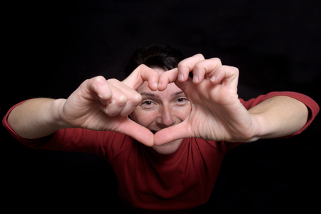 woman making a heart with her handsの写真素材