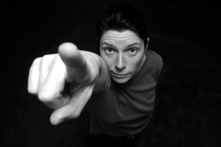 woman pointing on black background