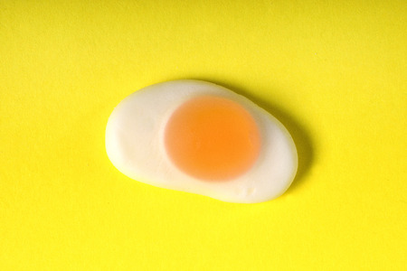 jelly candy fried egg over yellow backgroundの写真素材