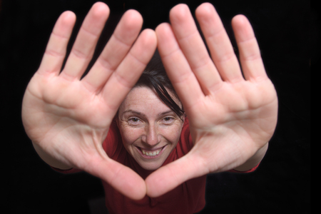 woman two hands up on black background