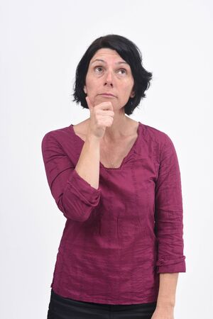 woman having a doubt or question on white backgroundの写真素材