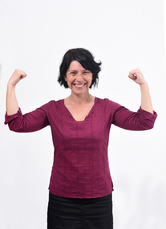 woman raising her arms and smiling in victory sign on white backgroundの写真素材