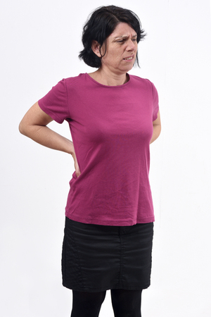 woman with pain back on whiteの写真素材