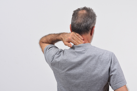 man with pain on nape on white backgroundの写真素材