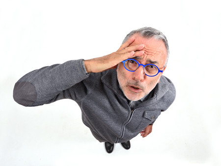 man with expression of forgetfulness or surprise on white backgroundの写真素材