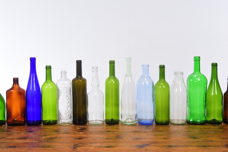 several bottles on top of a wooden table with a white backgroundの写真素材
