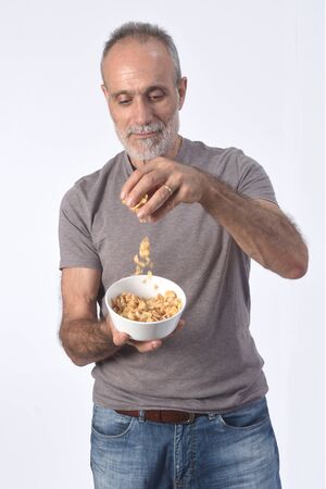 man with corn  flakes bar on white backgroundの写真素材