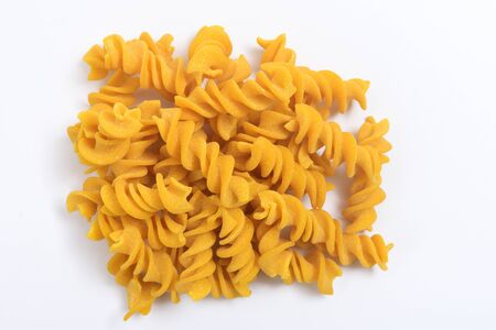 fusili pasta on white background, with rice and turmericの写真素材