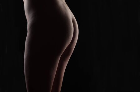 nude body of middle aged woman on black backgroundの写真素材