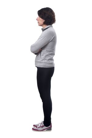 side view of a woman in white background, arms crossedの写真素材