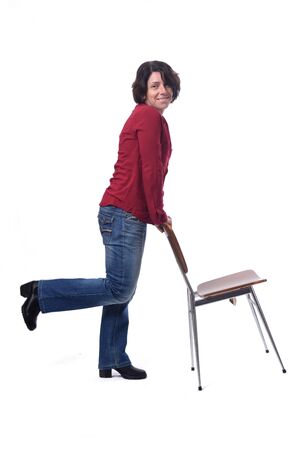 woman standing with a chair in white backgroundの写真素材