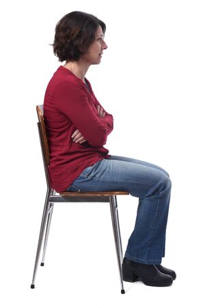 portrait of a woman sitting on a chair in white background,look side lの写真素材
