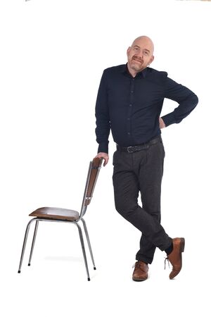 man standing with a chair in white backgroundの写真素材