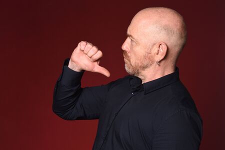 man pointing himself on red backgroundの写真素材