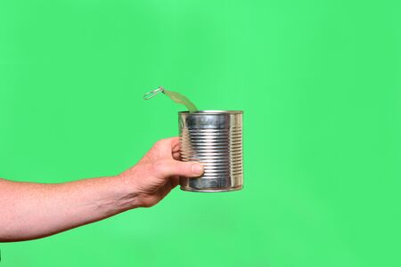 man holding a can on green background
