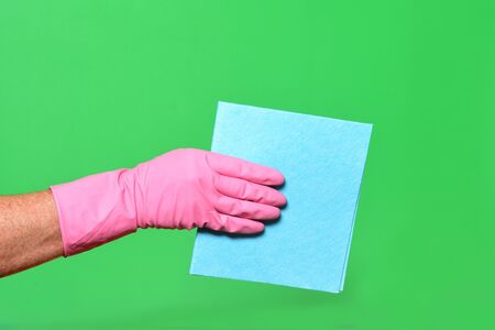 hand with baize on green background