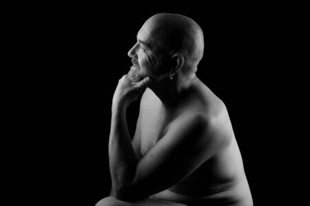 portrait of a man shirtless on black background, look sideの写真素材