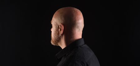 portrait of a man in low key, rear view of headの写真素材