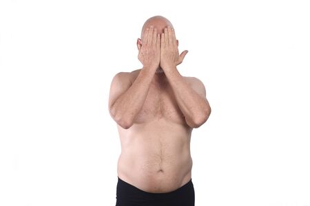 shirtless man cover his face on white backgroundの写真素材