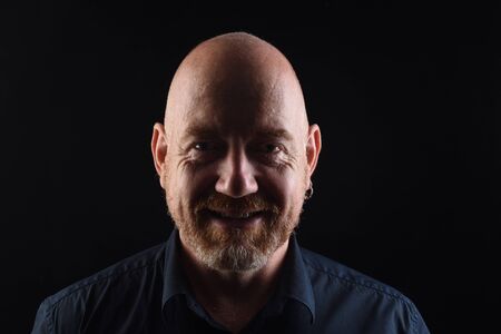 portrait of a man black background, smiling with teethの写真素材