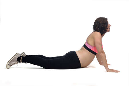 pregnant woman doing floor exercises on white background