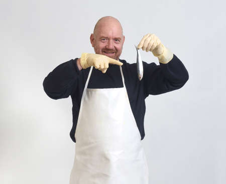 fishmonger pointing a sardine on white backgroundの写真素材
